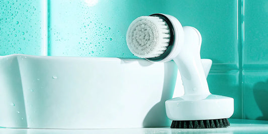 A facial cleansing brush with soft bristles, a key tool in a beginner's skincare routine.
