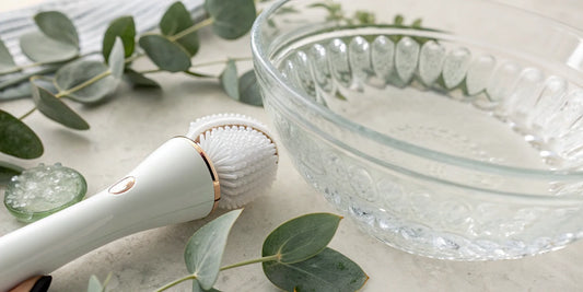 An advanced cleansing brush with soft bristles on a bathroom counter.